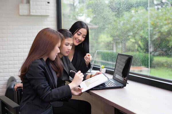 Group of business women having meeting in office.