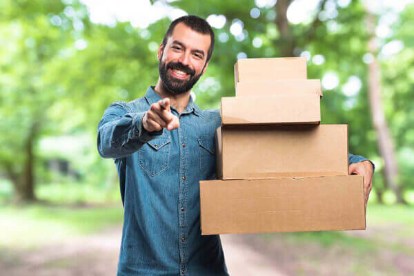 Man holding boxes on unfocused background