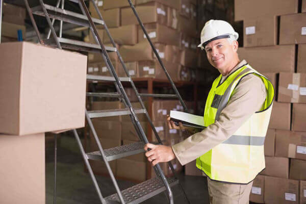 Portrait of worker with diary in the warehouse